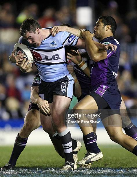 Luke Douglas of the Sharks is tackled during the round 21 NRL match between the Cronulla-Sutherland Sharks and the Melbourne Storm at Toyota Park...