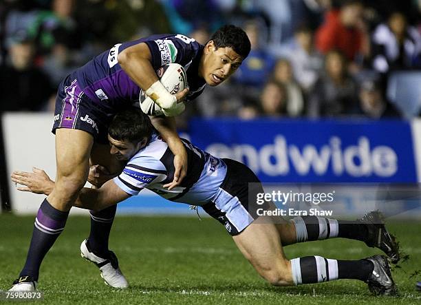 Israel Folau of the Storm is tackled by Brett Seymour of the Sharks during the round 21 NRL match between the Cronulla-Sutherland Sharks and the...