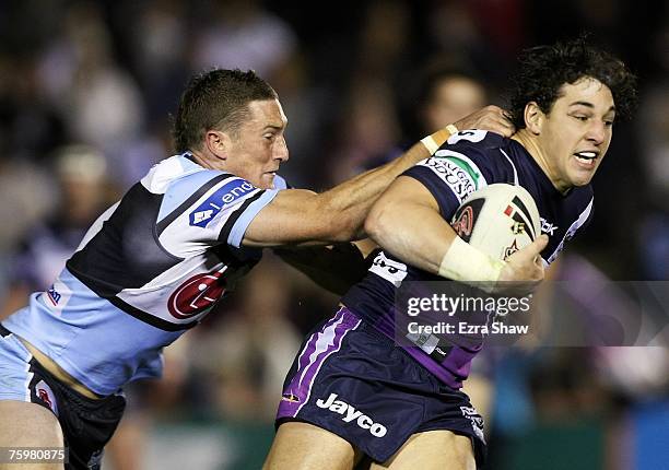 Billy Slater of the Storm is tackled by Ben Pomeroy of the Sharks during the round 21 NRL match between the Cronulla-Sutherland Sharks and the...