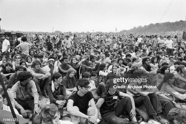 Music fans watch Richie Havens perform at the Woodstock Music and Art Fair in Bethel, New York State, 15th August 1969.