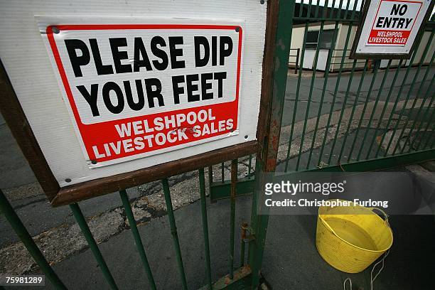 Sign urges visitors to use a footbath - which has been in use since the first outbreak of Foot and Mouth in 2001 - at the entrance to Welshpool...