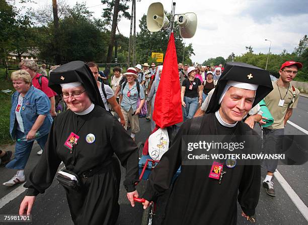 Two nuns pull a tricycle amongst a group of pilgrims from Warsaw as they walks through a Warsaw suburb 06 August 2007 as they take part in an annual...