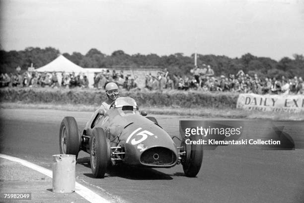 Alberto Ascari at speed past one of Silverstone's famous marker barrels in a Ferrari 500/F2 on his way to an easy victory at the British Grand Prix,...