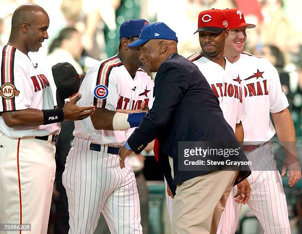 Ernie Banks aka "Mr. Cub is greeted by Barry Bonds Sammy Sosa, Ken Griffey Jr. And Jim Thome as he takes to the field as he is saluted as one of the...