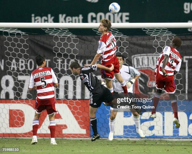 Clarence Goodson of FC Dallas heads the ball clear over Ben Olse of D.C. United during the match between DC United and SC Dallas at RFK Stadium on...