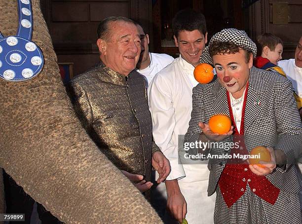 Restaurateur Sirio Maccioni watches as Ringling Brothers and Barnum and Bailey clown David Larible juggles oranges in front of Maccioni's Le Cirque...