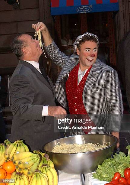 Ringling Brothers and Barnum and Bailey clown David Larible feeds spaghetti to Le Cirque 2000 restaurant executive chef Pierre Scaedelin March 28,...