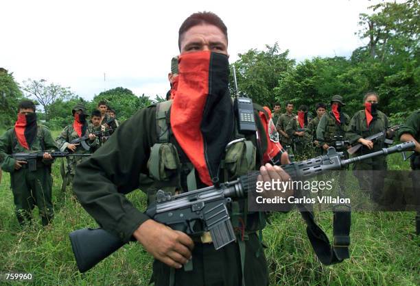 National Liberation Army soldiers stand in formation at one of their camps near the front line April 11, 2002 in the Arauca province of Colombia. The...