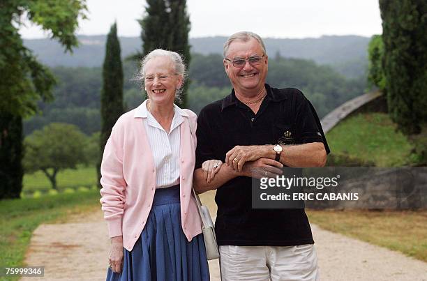 Denmark's Queen Margrethe and her husband Prince consort Henrik pose for photographers as they spend their holidays in their castle in Caix South...