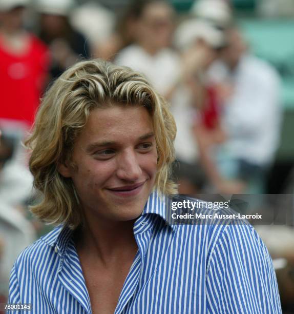 Nicolas Sarkozy's son Jean Sarkozy follows Switzerland's Roger Federer playing Russia's Nikolay Davydenko, during a semifinal match of the French...