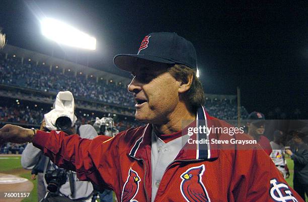 Tony LaRussa of the St. Louis Cardinals receives congratulations as he heads for the dugout after his team defeated the Los Angeles Dodgers 6-2 in...