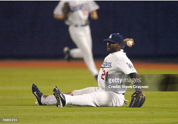 Milton Bradley of the Los Angeles Dodgers fields a ball and throws to first base for a double play in game four of the National League Division...