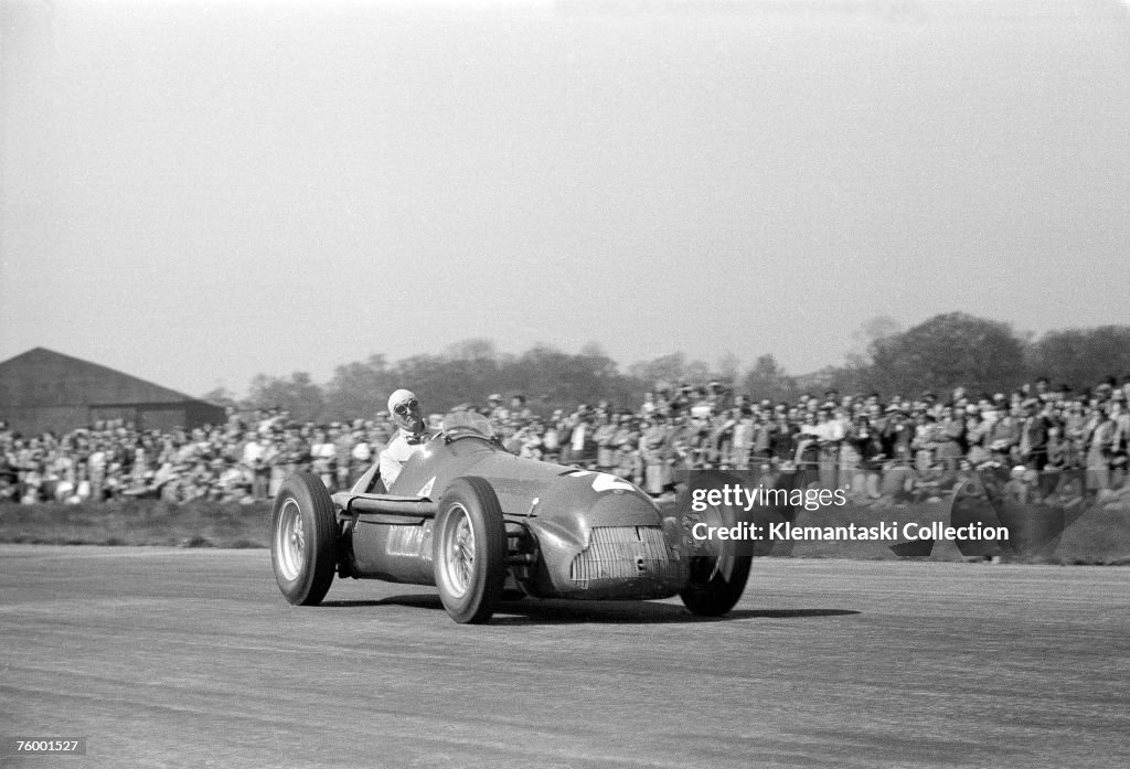 Farina Racing Driver Nino Farina, putting on one of his patented faces of exertion, in his ...