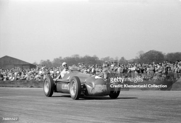 Nino Farina, putting on one of his patented faces of exertion, in his Alfa Romeo 159 during the British Grand Prix, Silverstone, 13th May 1950.