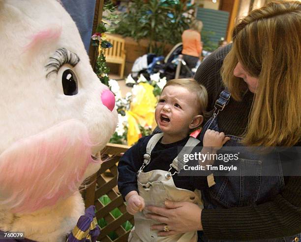 Fifteen-month-old Jack Dullum, in the arms of his mother Chris Dullum from Niles, IL, reacts as he meets the Easter Bunny March 28, 2002 at Golf Mill...