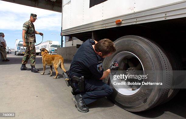 Customs Inspector checks a truck tire at the Bridge of Americas port of entry cargo facility March 28, 2002 in El Paso, TX. New non-intrusive imaging...