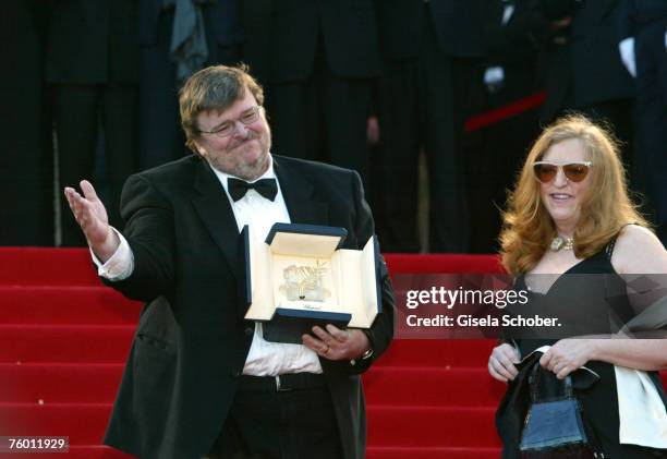 Michael Moore, with the Palme D'Or prize, and wife Kathleen Glynn