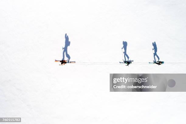 aerial view of skiers and their shadows, bad gastein, salzburg, austria - bad gastein stockfoto's en -beelden