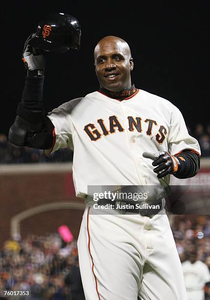 Barry Bonds of the San Francisco Giants raises his helmet to the crowd after hitting his career home run during the Major League Baseball game...