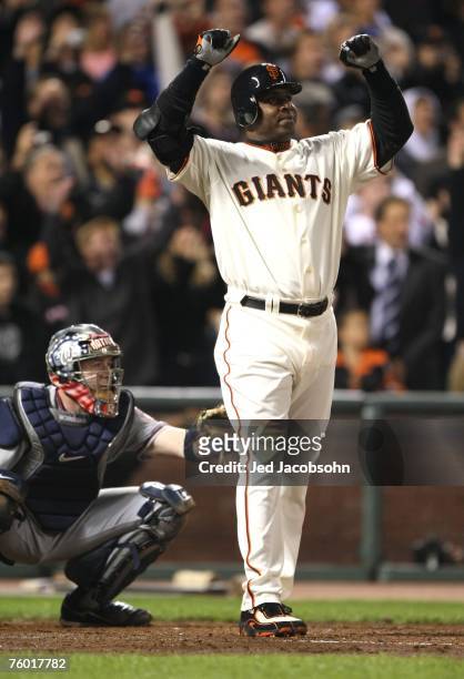 Barry Bonds of the San Francisco Giants raises his fists after hitting career home run during the Major League Baseball game against the Washington...