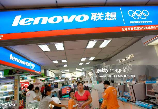 Shoppers are seen at an outlet for China's personal computer maker Lenovo Group at a shopping center in Beijing, 08 August 2007. China's Lenovo...