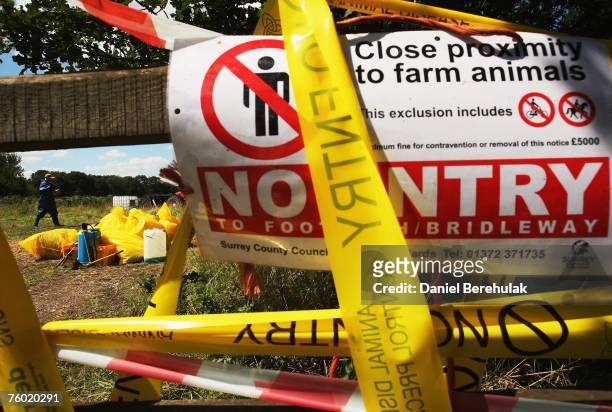 Employee sanitises waste at the second site of an outbreak of foot and mouth disease near the village of Normandy on August 8, 2007 in Surrey,...