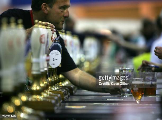 Beer enthusiasts buy real ale at the Beer Festival in Earls Court on August 8, 2007 in London, England. The beer festival is an annual event...