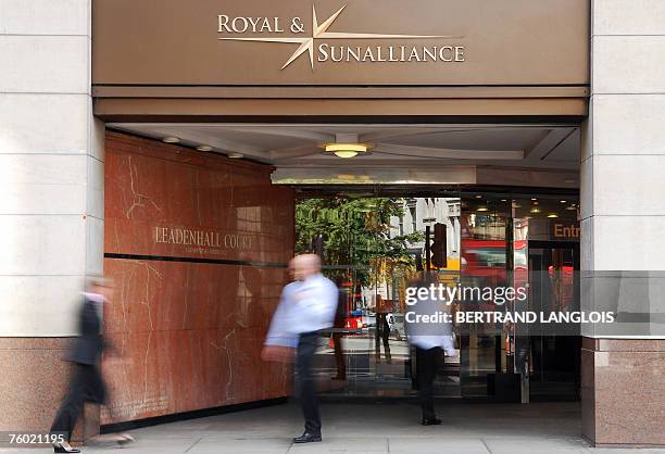 Pedestrians walk by the offices of the Royal and Sun Alliance in London, 08 August 2007. British insurer Royal and Sun Alliance said today it planned...