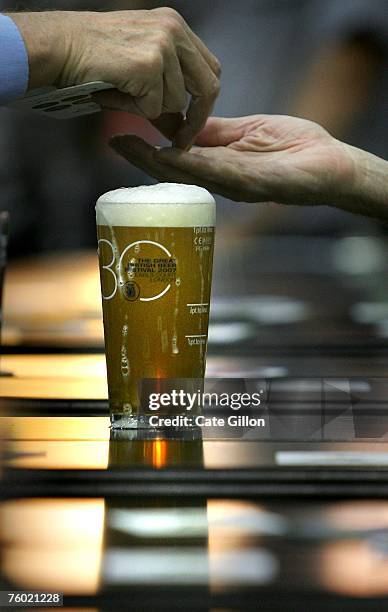 Beer enthusiasts buy real ale at the Beer Festival in Earls Court on August 8, 2007 in London, England. The beer festival is an annual event...