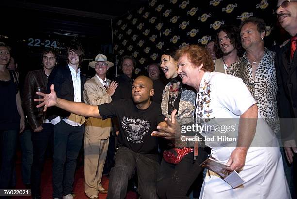 Darryl "DMC" McDaniels poses with celebrities including Rita Gilligan, cultural attache, dressed as a waitress, outside the newest Hard Rock Cafe at...