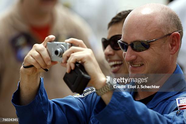 Astronaut Mark Kelly's brother of Space Shuttle Endeavour Commander Scott Kelly snaps a photo while the flight crew walks out of the Operations and...