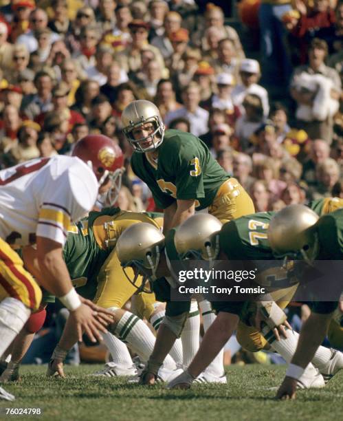 Quarterback Joe Montana of the University of Notre Dame Fighting Irish calls out the signals at the line of scrimmage during a game on November 25,...