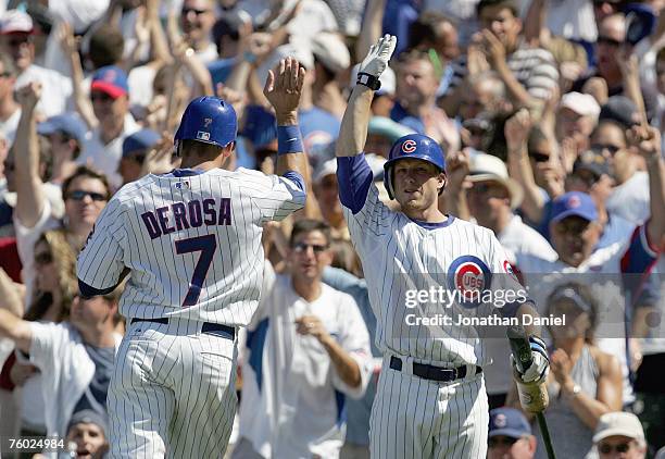 Mark DeRosa celebrates iwth Mike Fontenot of the Chicago Cubs during the game against the New York Mets at Wrigley Field on August 3, 2007 in...