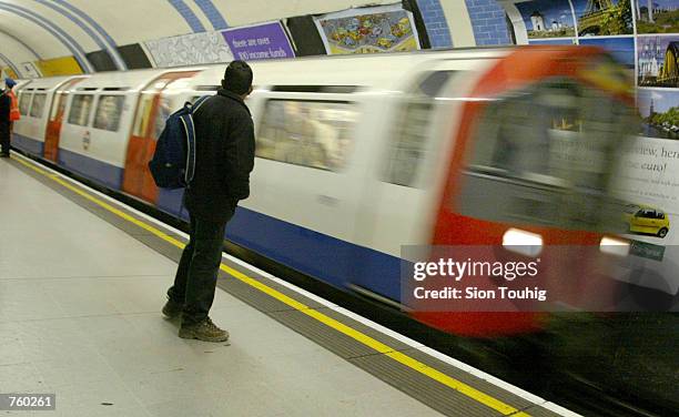 Commuter waits for an incoming London Underground train March 29, 2002 at Green Park Underground station in London. Confidential documents have...