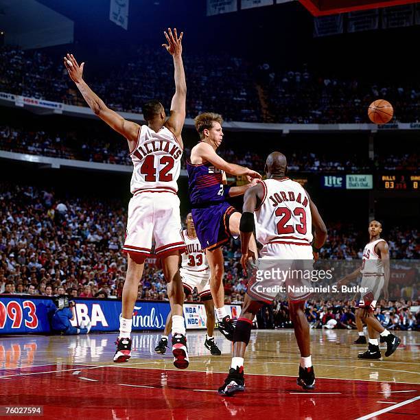 Danny Ainge of the Phoenix Suns attempts a pass against Scott Williams and Michael Jordan of the Chicago Bulls in Game Three of the 1993 NBA Finals...
