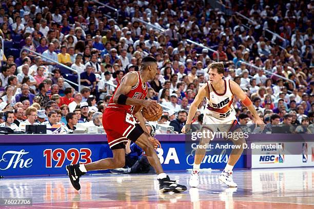 Scottie Pippen of the Chicago Bulls dribbles upcourt against Danny Ainge of the Phoenix Suns in Game Two of the 1993 NBA Finals on June 11, 1993 at...