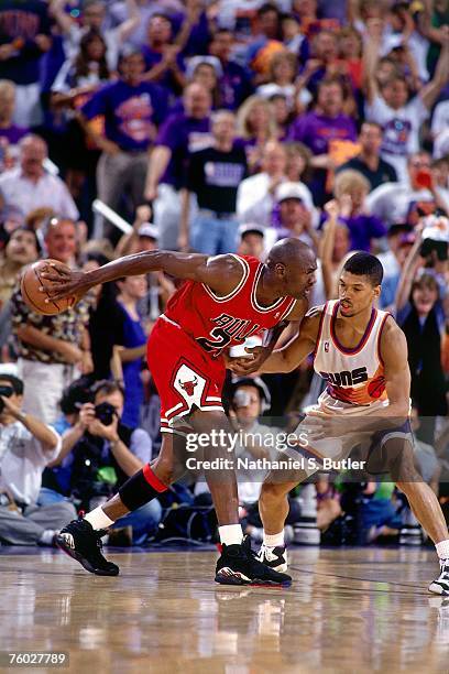 Michael Jordan of the Chicago Bulls looks to drive to the basket against Kevin Johnson of the Phoenix Suns in Game Six of the 1993 NBA Finals on June...