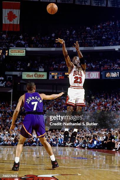 Michael Jordan of the Chicago Bulls attempts a shot against Kevin Johnson of the Phoenix Suns in Game Five of the 1993 NBA Finals on June 18, 1993 at...