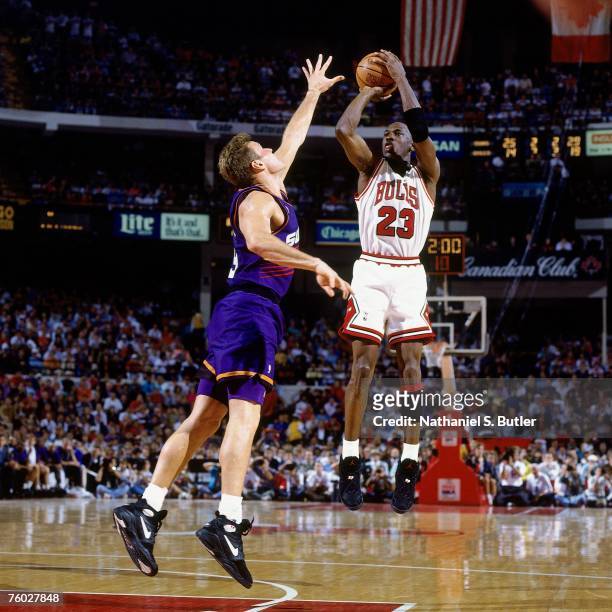 Michael Jordan of the Chicago Bulls attempts a shot against Dan Majerle of the Phoenix Suns in Game Five of the 1993 NBA Finals on June 18, 1993 at...