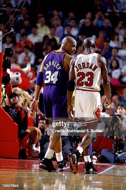 Charles Barkley of the Phoenix Suns chats with Michael Jordan of the Chicago Bulls in Game Five of the 1993 NBA Finals on June 18, 1993 at the...