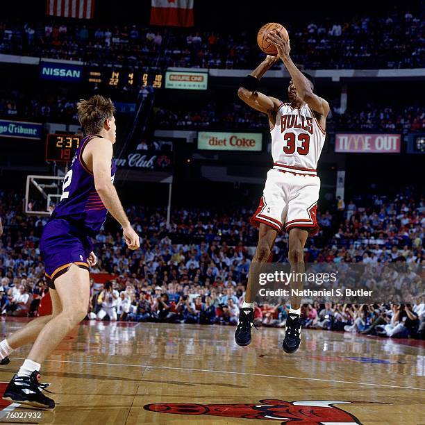 Scottie Pippen of the Chicago Bulls attempts a shot against Danny Ainge of the Phoenix Suns in Game Four of the 1993 NBA Finals on June 16, 1993 at...