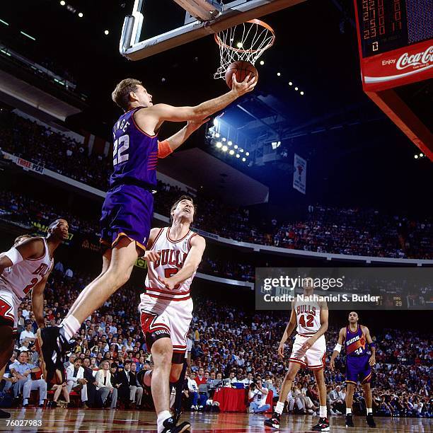 Danny Ainge of the Phoenix Suns attempts a layup against John Paxson of the Chicago Bulls in Game Four of the 1993 NBA Finals on June 16, 1993 at the...