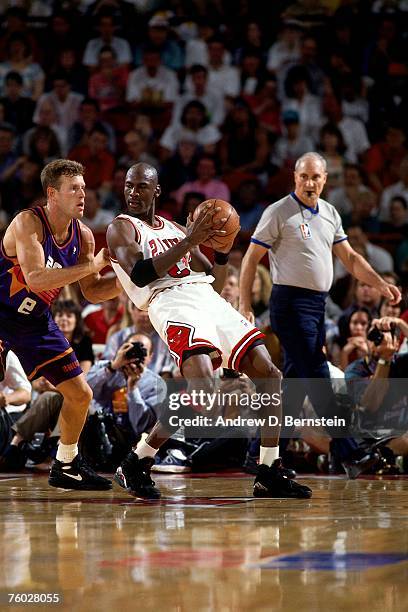 Michael Jordan of the Chicago Bulls posts up against Dan Majerle of the Phoenix Suns in Game Three of the 1993 NBA Finals on June 13, 1993 at the...