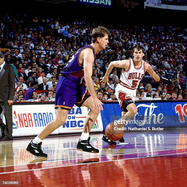 Danny Ainge of the Phoenix Suns dribbles up court against John Paxson of the Chicago Bulls in Game Four of the 1993 NBA Finals on June 16, 1993 at...