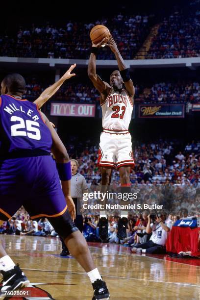 Michael Jordan of the Chicago Bulls attempts a shot against Oliver Miller of the Phoenix Suns in Game Three of the 1993 NBA Finals on June 13, 1993...