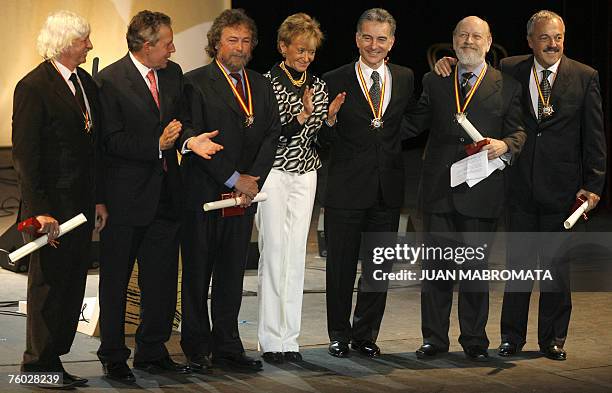 Spain's vice president Maria Teresa Fernandez de la Vega poses with Spanish ambassador to Argentina Alfredo Estrella and "Les Luthiers" ensemble's...