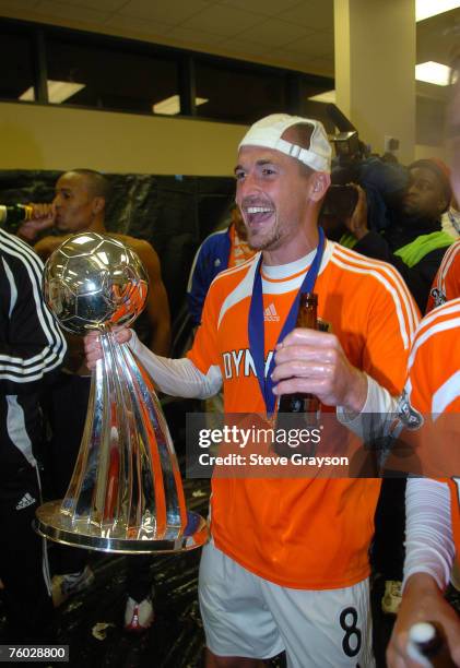 Paul Dalglish of the Houston Dynamo celebrates in the locker room after defeating the New England Revolution in the 2006 MLS Cup at Pizza Hut Park in...