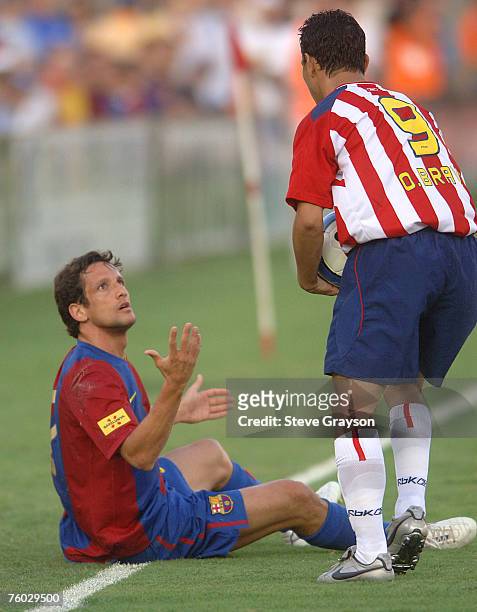 Ludovic Guily of FC Barcelona confronts Omar Bravo of CD Guadalajara after a collision during their International Friendly at the Los Angeles...