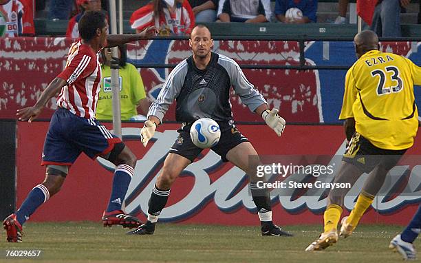 Preston Burpo of Chivas USA stops a shot by Ezra Hendrickson of the Columbus Crew as Carlos Llamosa looks on during their contest at The Home Depot...