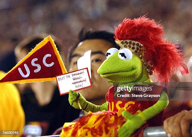 Kermit the Frog doll is dressed in USC colors with a banner making reference to the current and former school mascots of the Stanford Cardinal during...